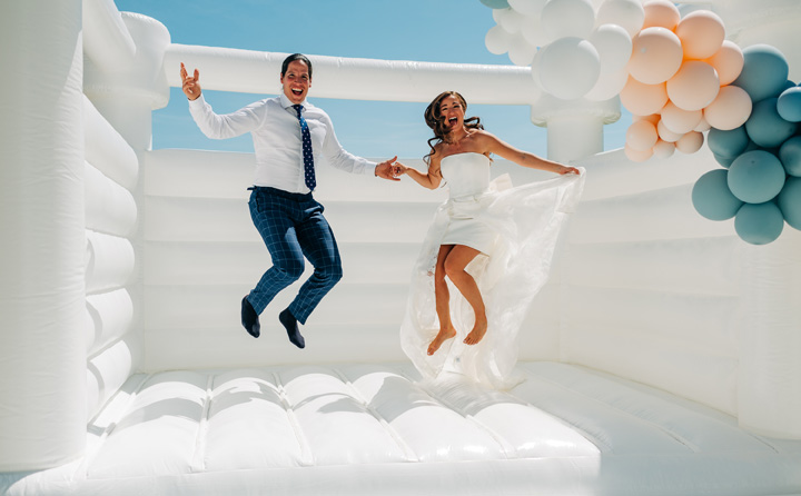 Happy couple using the bounce house